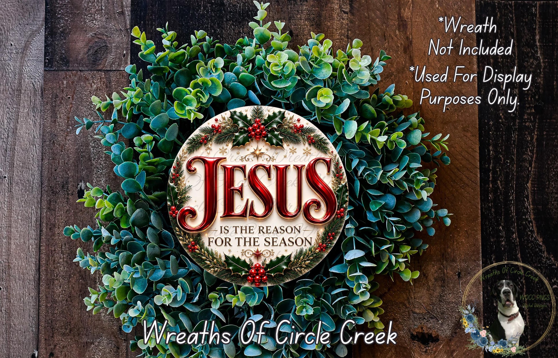 a Christmas wreath with the text "Jesus is the reason for the season" displayed on it. The wreath is made of green and red foliage, and there is a small dog in the bottom right corner of the image.