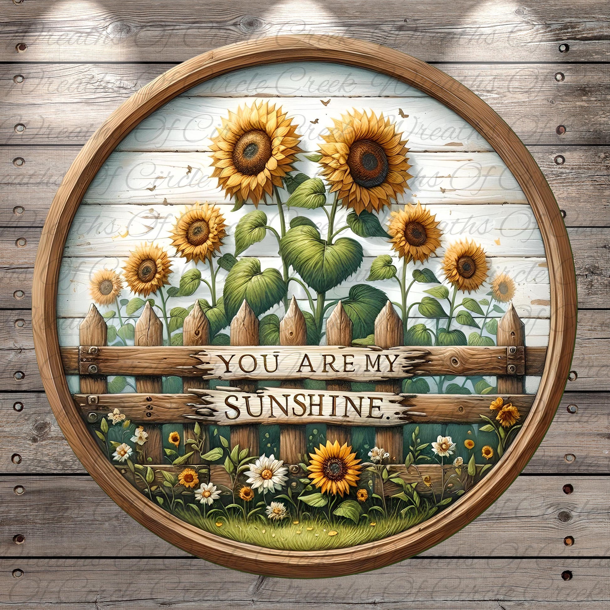 A circular wooden frame with a painted scene of a sunflower garden, featuring a wooden fence with the text "You are my sunshine" written on it.