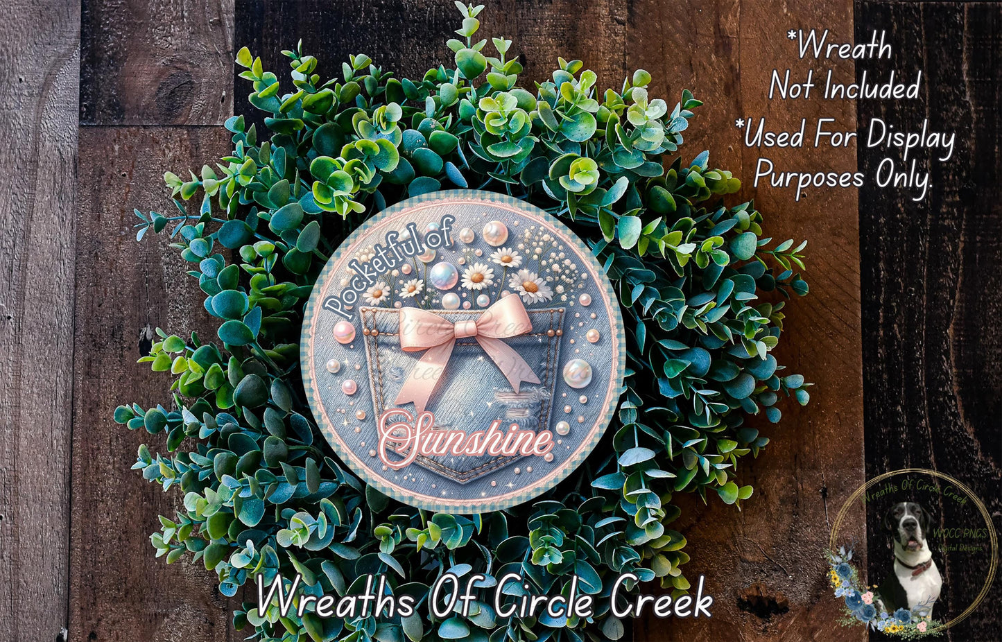 A wreath made of green leaves and flowers, with a circular design featuring a ribbon and the text "Sunshine" in the center.