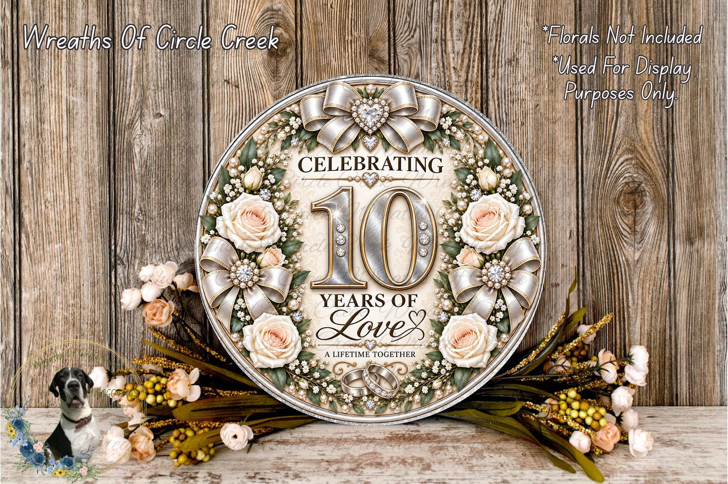 A decorative sign celebrating the 10th anniversary of a couple, surrounded by flowers and greenery.