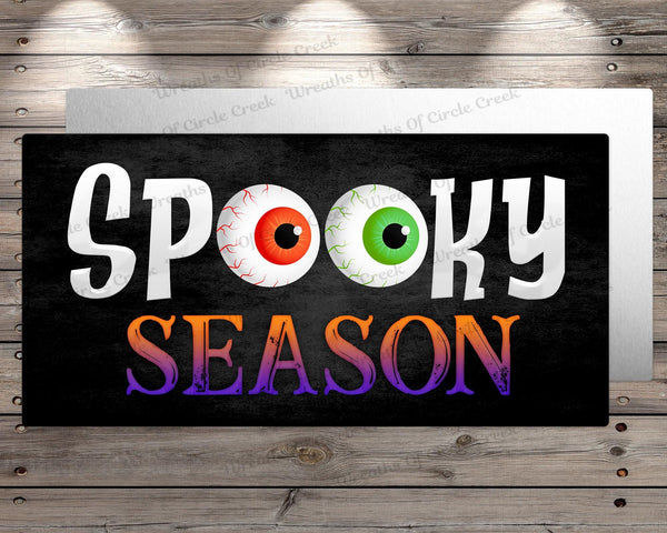 a sign that says spooky season on it
