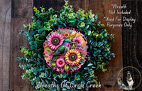 a wreath with flowers and a bird on it