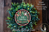 A Christmas wreath made of evergreen branches and a red and white checkered border, with a snowman and gingerbread man decoration. The wreath is surrounded by greenery and has a "Merry Christmas" sign in the center.
