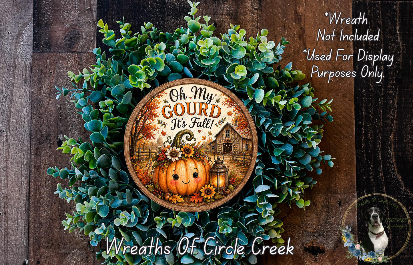 a wreath with a pumpkin and a barn, surrounded by greenery, and a sign that reads "Oh My Gourd It's Fall".
