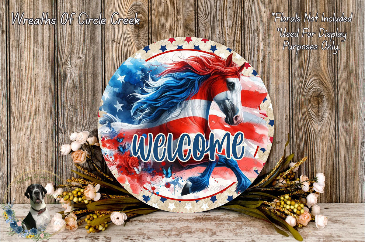 a circular sign with a patriotic design, including a horse and an American flag, surrounded by flowers and greenery. The sign has the word "Welcome" written on it.