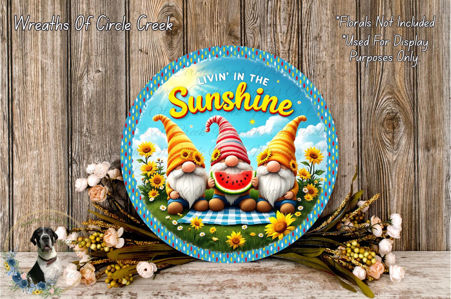 A round metal sign with a whimsical design featuring three gnomes in a sunny field surrounded by flowers.