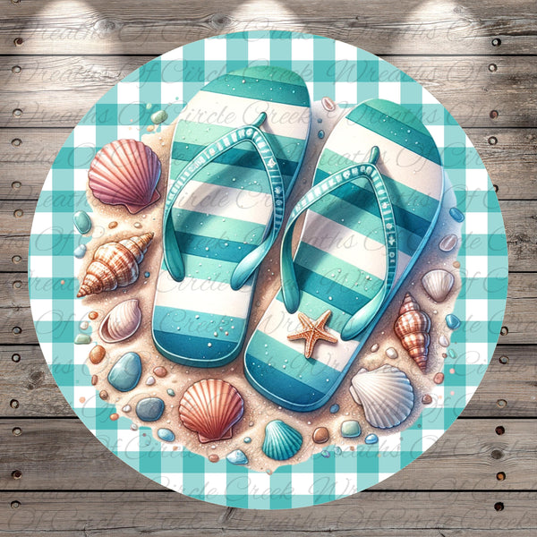 A pair of blue and white striped flip-flops rests on a beach scene, surrounded by seashells, rocks, and starfish.