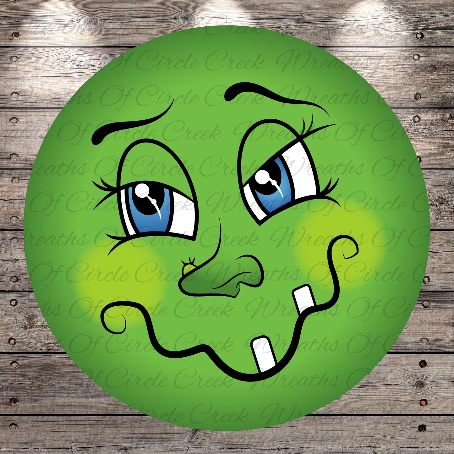 A green, cartoon-like face with large blue eyes, a small nose, and a mustache, with a slightly mischievous expression.