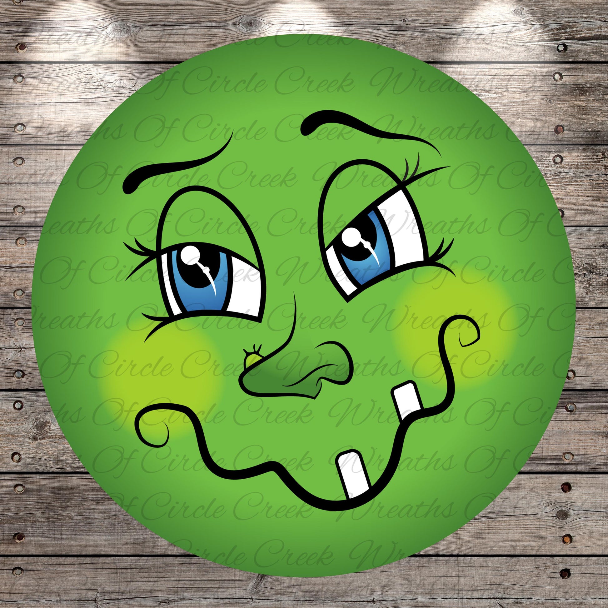 A green, cartoon-like face with large blue eyes, a small nose, and a mustache, with a slightly mischievous expression.
