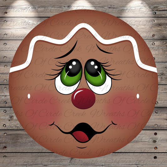 A close-up of a gingerbread man face with large eyes, a red nose, and a wide smile, set against a wooden background.