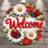 A decorative round sign with the word "Welcome" written on it, surrounded by a floral arrangement of white and red flowers, red and white flowers, and red and black ladybugs.