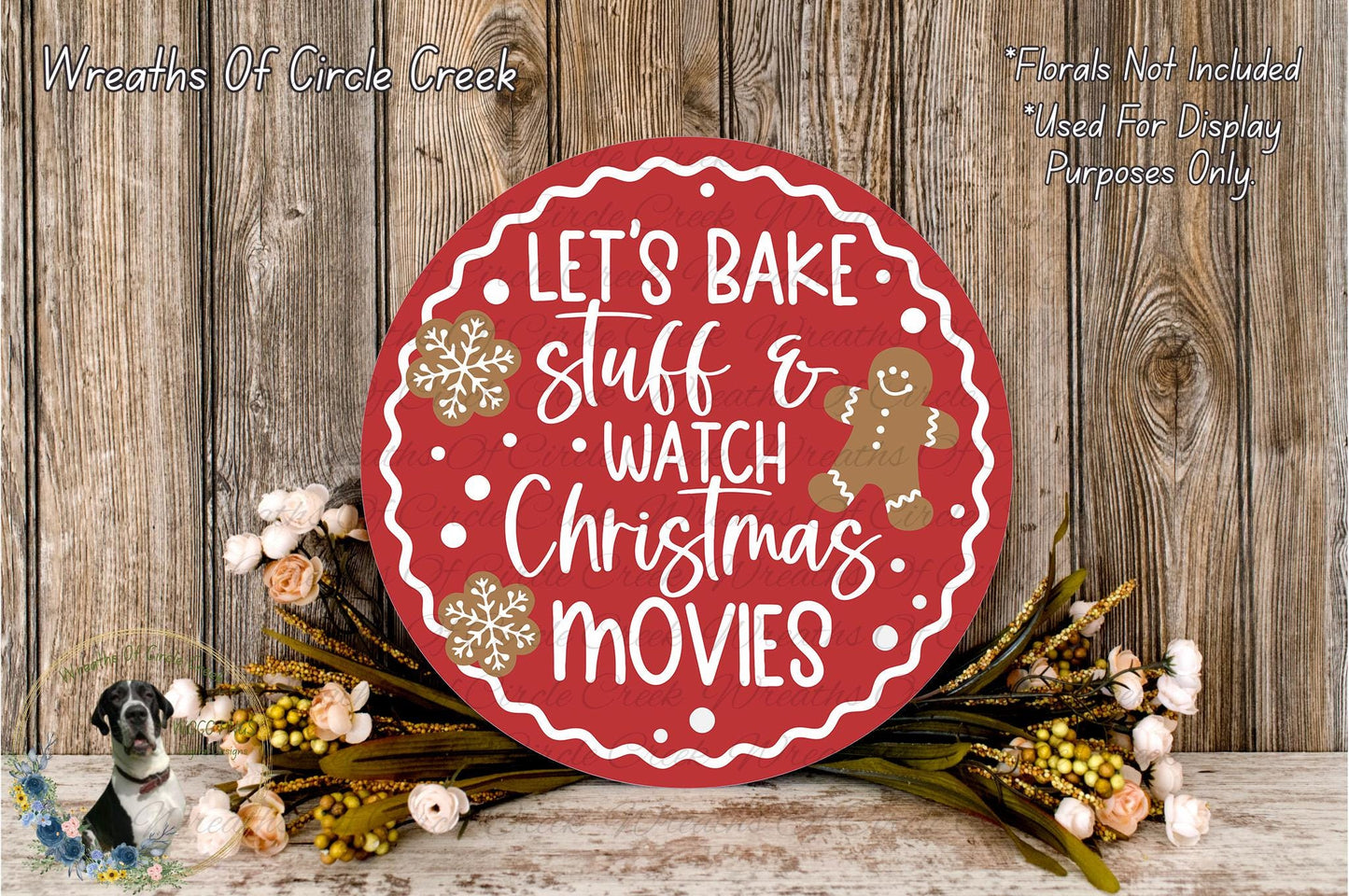 A red circular sign with white text that says "Let's Bake Stuff & Watch Christmas Movies" is surrounded by a wreath of flowers and a gingerbread man decoration.