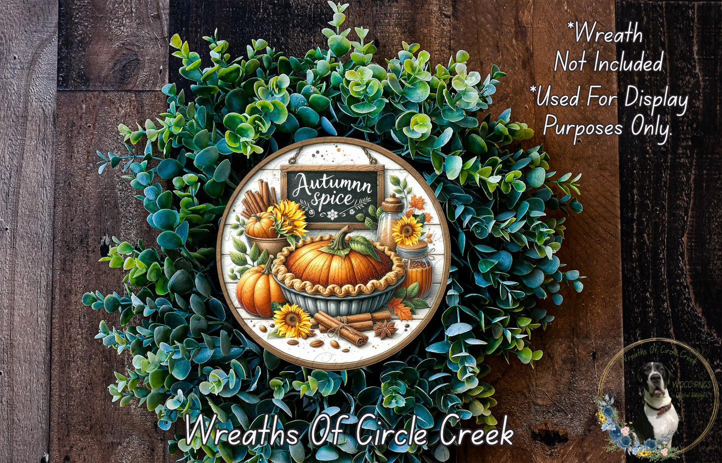 a wreath made of various autumn-themed elements, including a pumpkin, sunflowers, and cinnamon sticks. The wreath is displayed on a wooden surface, and there is a sign that reads "Autumn Spice" in the center.