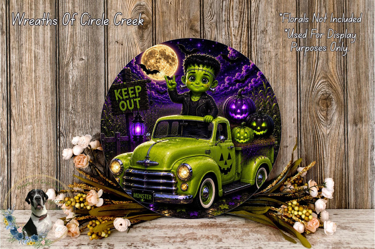 A Halloween-themed decoration featuring a green truck with a jack-o-lantern and a skull on the bed, surrounded by flowers and a "KEEP OUT" sign.