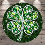 A circular design featuring a four-leaf clover adorned with sparkling green and white gemstones, set against a wooden background.