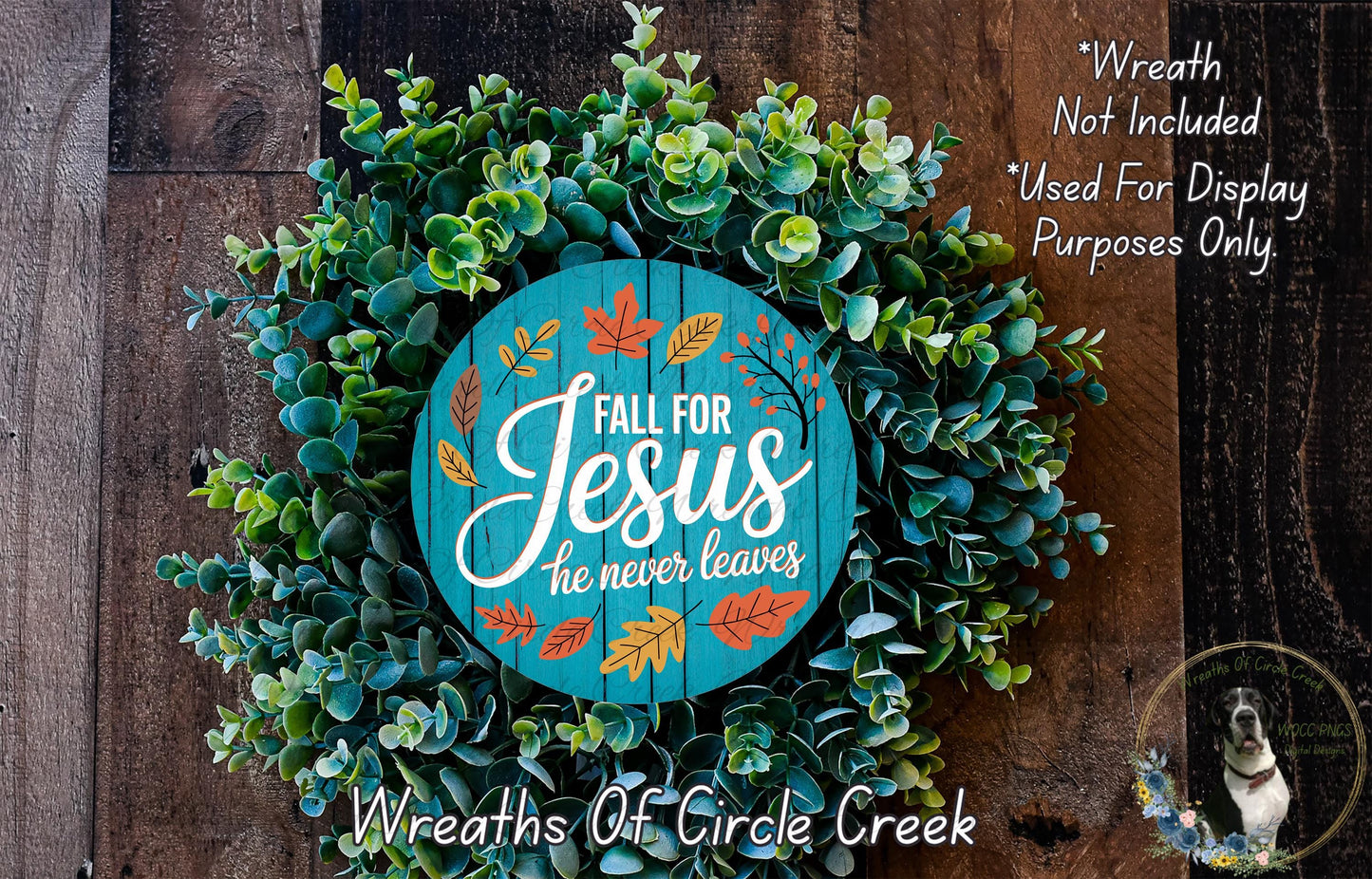 a wreath made of green leaves and a wooden sign with the text "Fall for Jesus he never leaves" against a wooden background.