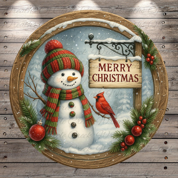 A snowman wearing a red and green striped scarf, holding a sign that says "Merry Christmas", with a red cardinal perched on a branch and red berries on the snowman's body.
