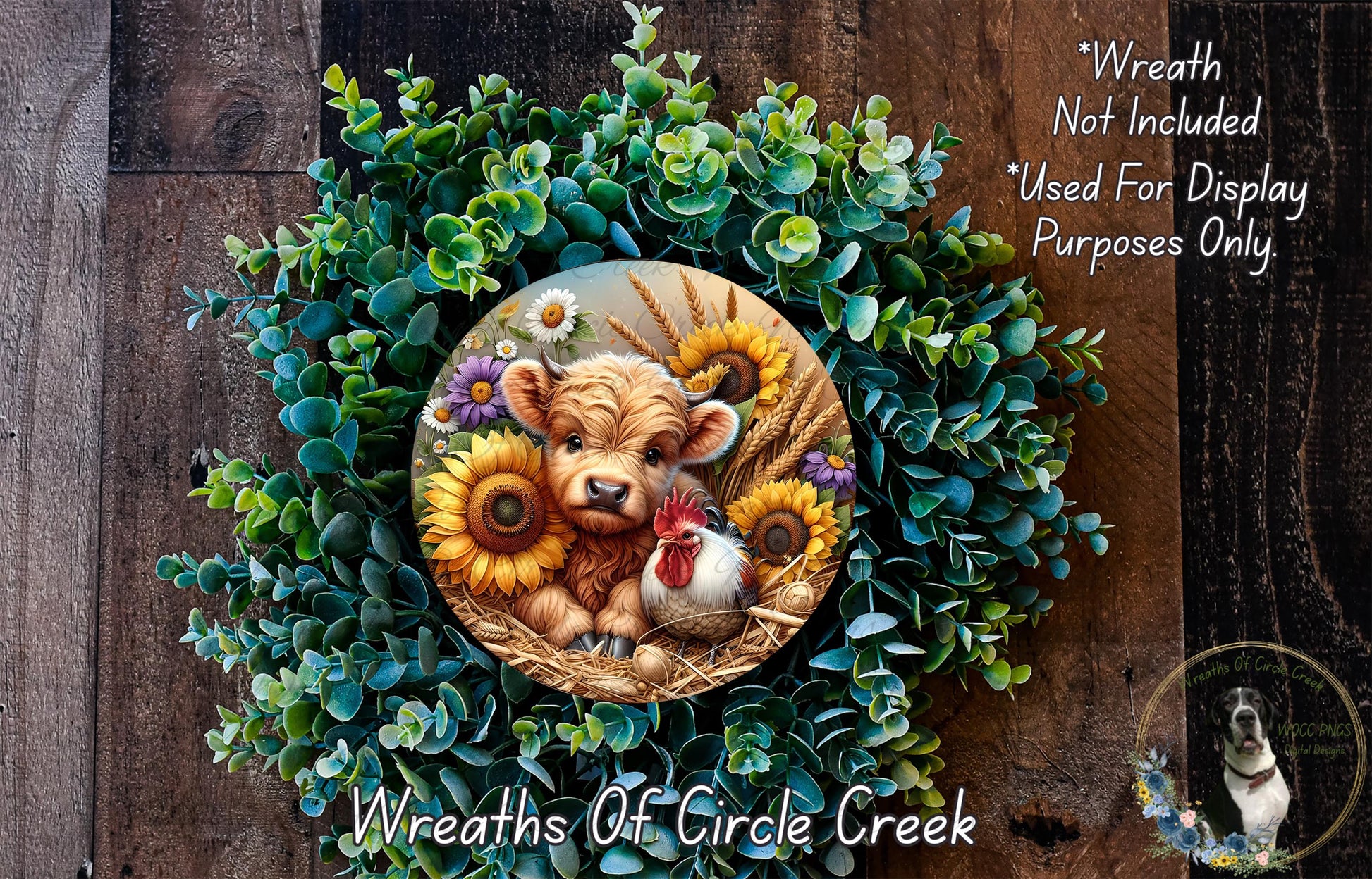 a wreath with a cow, chicken, and sunflowers, surrounded by a lush green wreath. The wreath is displayed on a wooden surface, and there is a small dog in the bottom right corner of the image.
