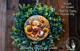 a wreath with a cow, chicken, and sunflowers, surrounded by a lush green wreath. The wreath is displayed on a wooden surface, and there is a small dog in the bottom right corner of the image.