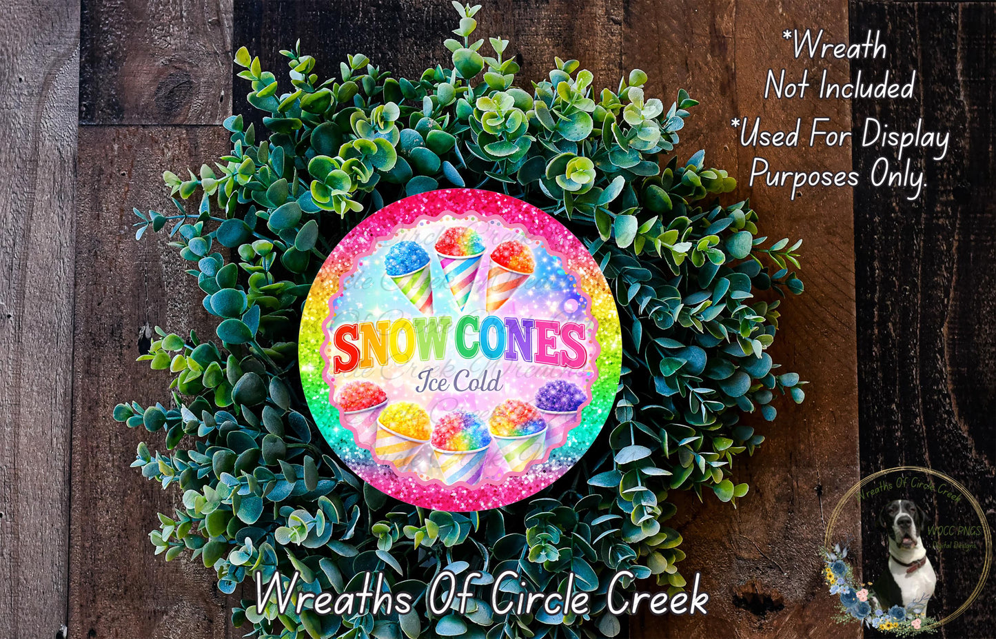 A wreath made of green leaves and featuring a colorful sign that says "Snow Cones Ice Cold".