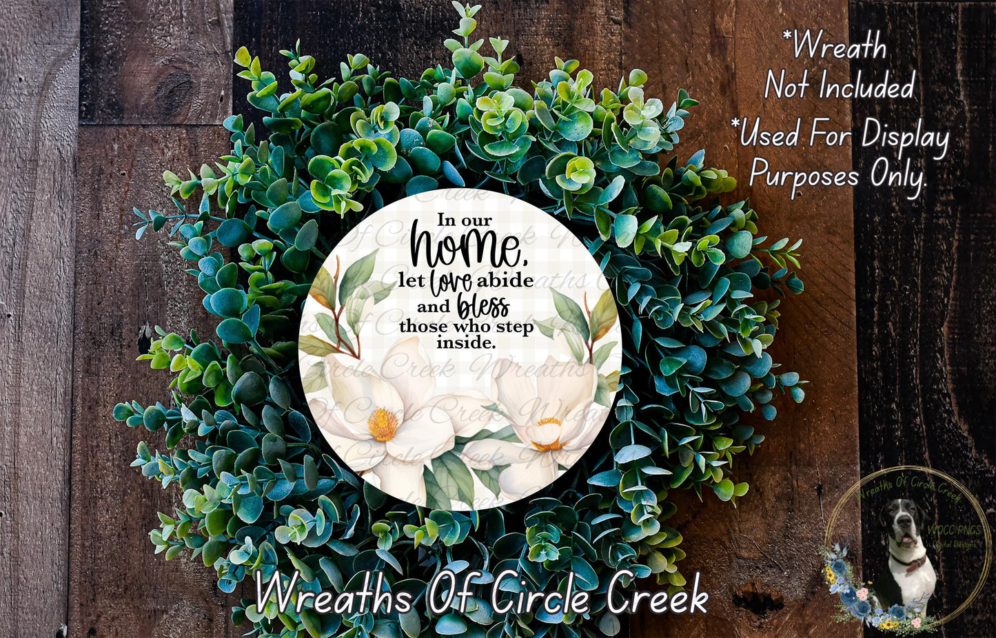 a wreath made of various green and white flowers, with a circular white sign in the center that contains a quote about the importance of home and family.