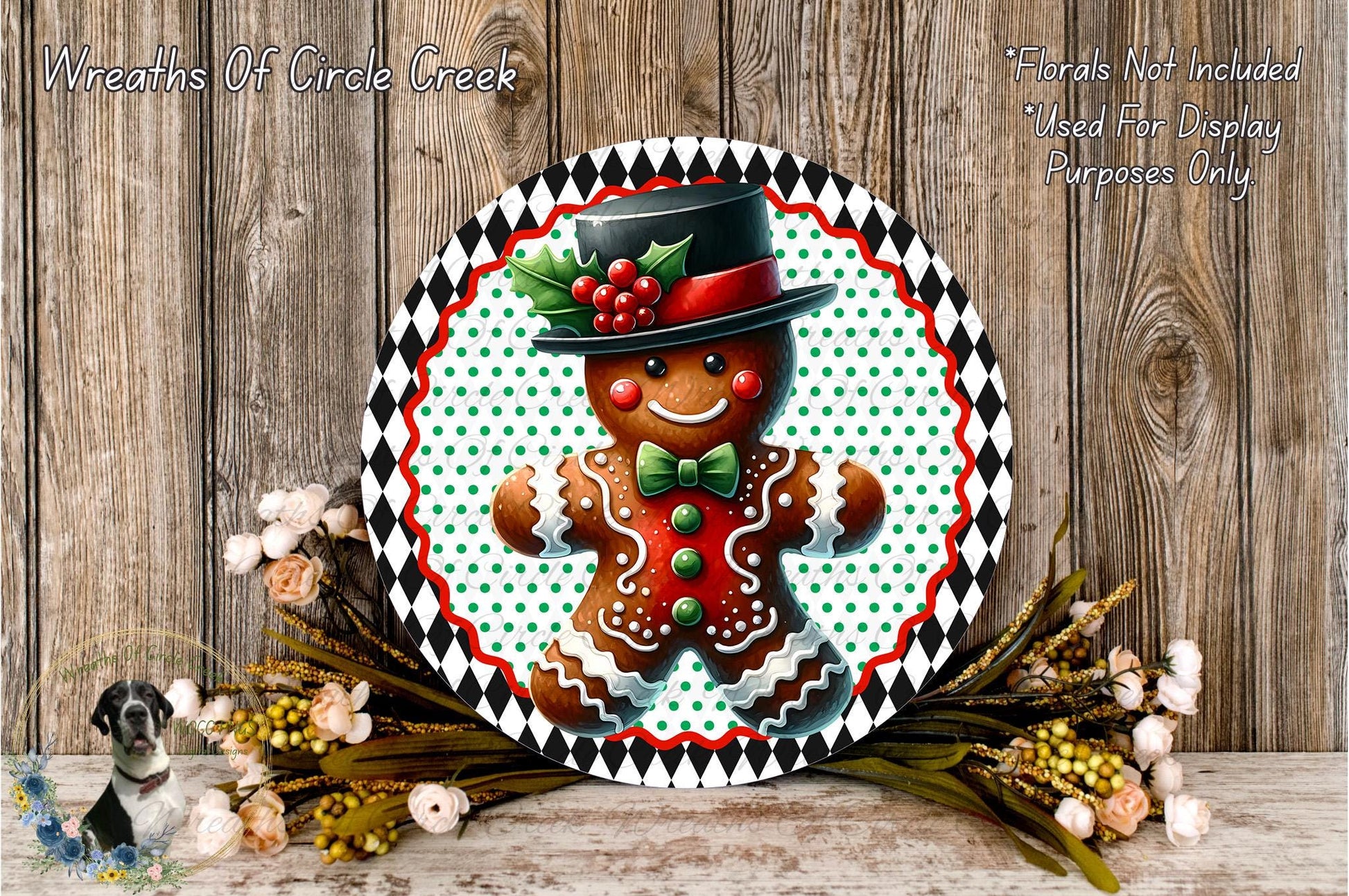 A gingerbread man wearing a black top hat and red bowtie, surrounded by a wreath of flowers and a wooden background.