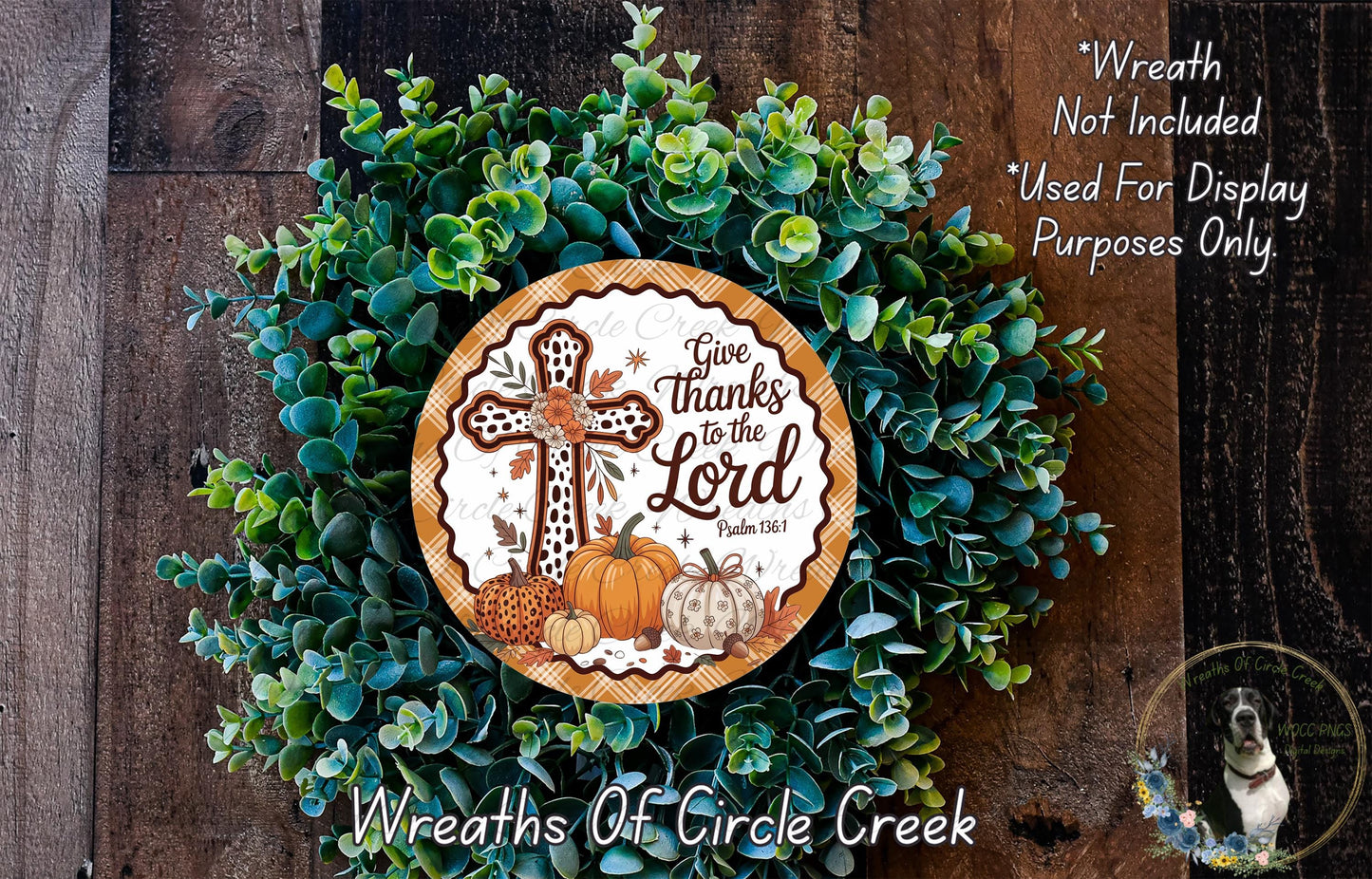 a wreath made of green leaves and a cross, with a decorative plate in the center that says "Give thanks to the Lord" and includes a pumpkin and a dog.