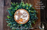 a wreath made of green leaves and a cross, with a decorative plate in the center that says "Give thanks to the Lord" and includes a pumpkin and a dog.