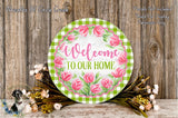 a round sign with a floral design, surrounded by a wreath of flowers and greenery, placed on a wooden surface.