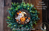 a Halloween-themed wreath with a ghost, a cat, and a pumpkin. The wreath is made of green foliage and has a decorative border. The text in the image includes a warning that the wreath is not included in the display and is used for display purposes only.
