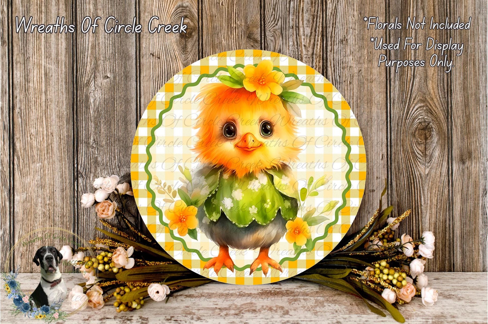 A decorative round plate featuring a cheerful yellow chick wearing a green dress and a flower crown, surrounded by a floral arrangement and a wooden background.