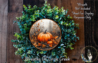 a wreath with a picture of a pumpkin on it