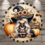 A whimsical illustration of a young girl with long, flowing hair wearing a witch's hat, surrounded by pumpkins, a black cat, and sunflowers. The girl is sitting on a wooden surface, and the background features a wooden wall with the text "Happy Halloween" written on it.