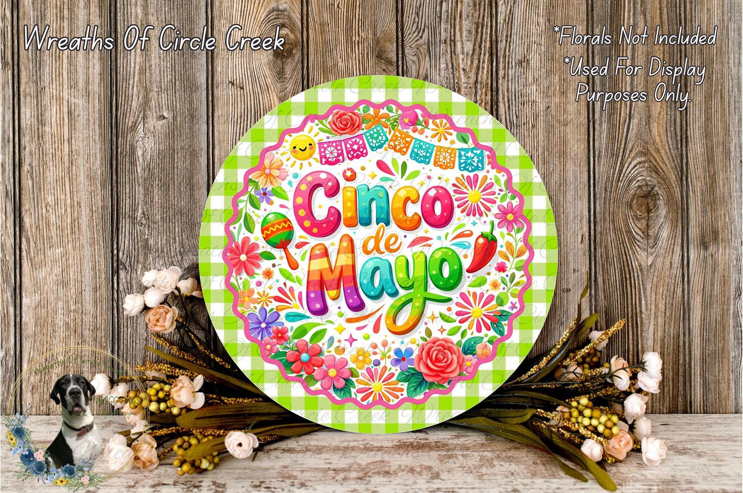 a vibrant and colorful Cinco de Mayo sign, surrounded by a floral arrangement and a wooden background.