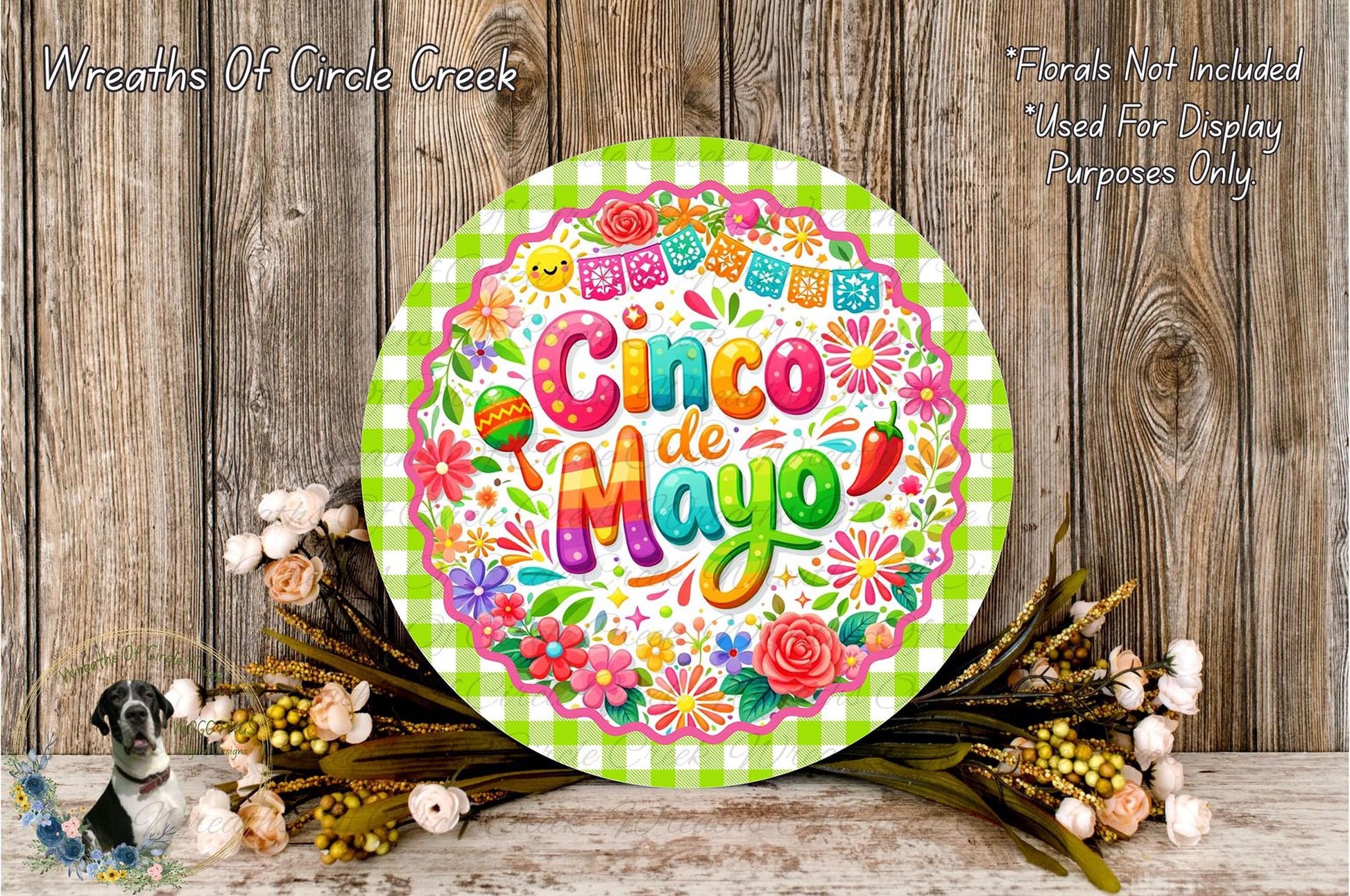 a vibrant and colorful Cinco de Mayo sign, surrounded by a floral arrangement and a wooden background.