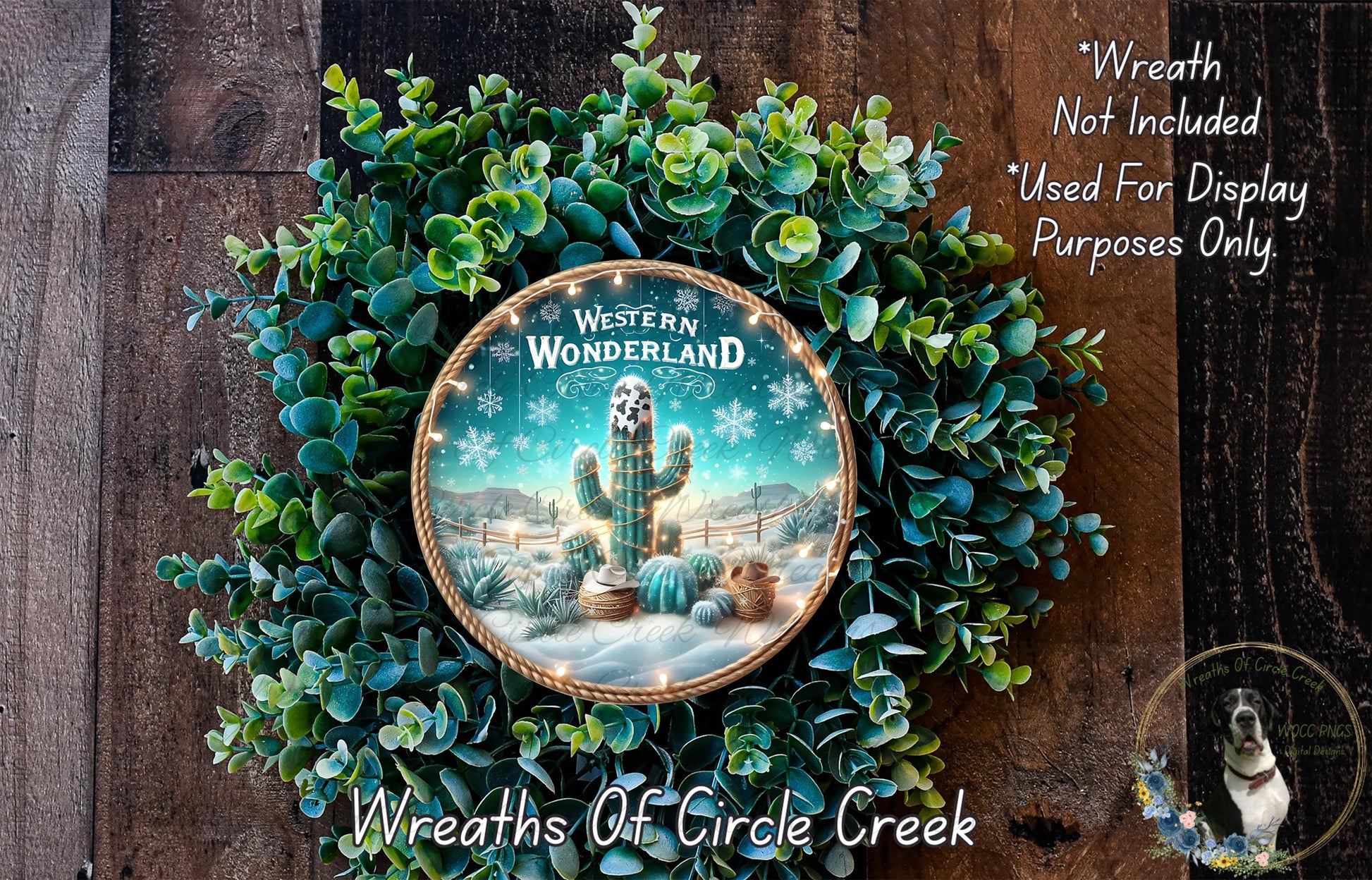 A wreath made of green plants and a decorative plate featuring a desert scene with a cactus and a snowman.