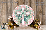 a round wooden plaque with a cross design, surrounded by a floral arrangement and a wooden background.