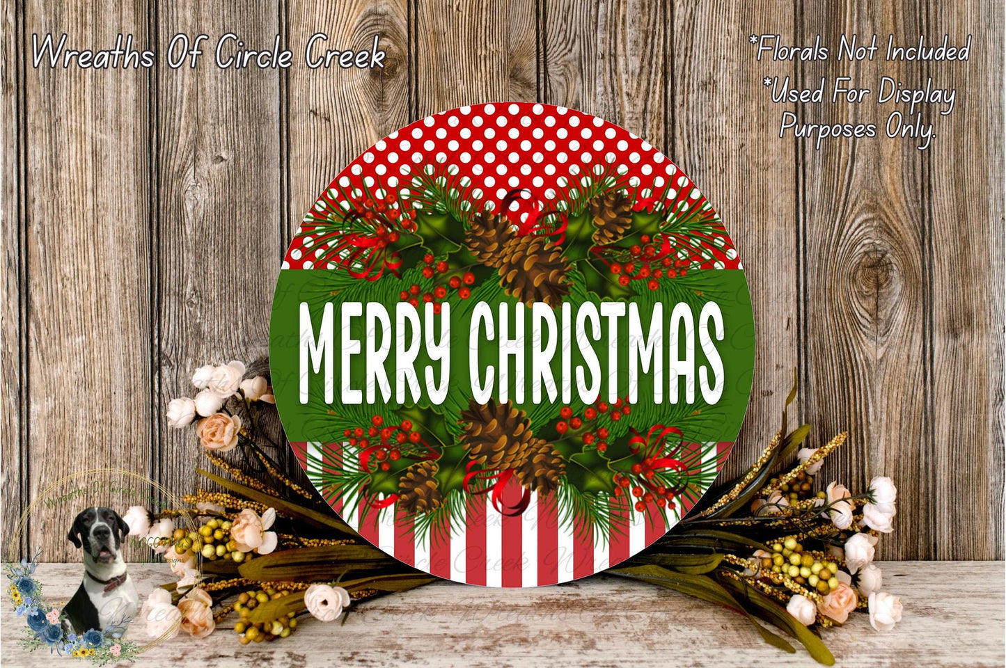 A festive Christmas wreath with the text "MERRY CHRISTMAS" displayed prominently. The wreath is adorned with pine cones, greenery, and red berries, creating a cheerful holiday scene.