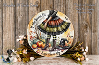 A decorative plate featuring a whimsical illustration of a woman in a colorful, ruffled dress, surrounded by autumnal elements such as pumpkins and flowers, with the text "If the boots fit, lace them up" and "Lace them up" written on it.