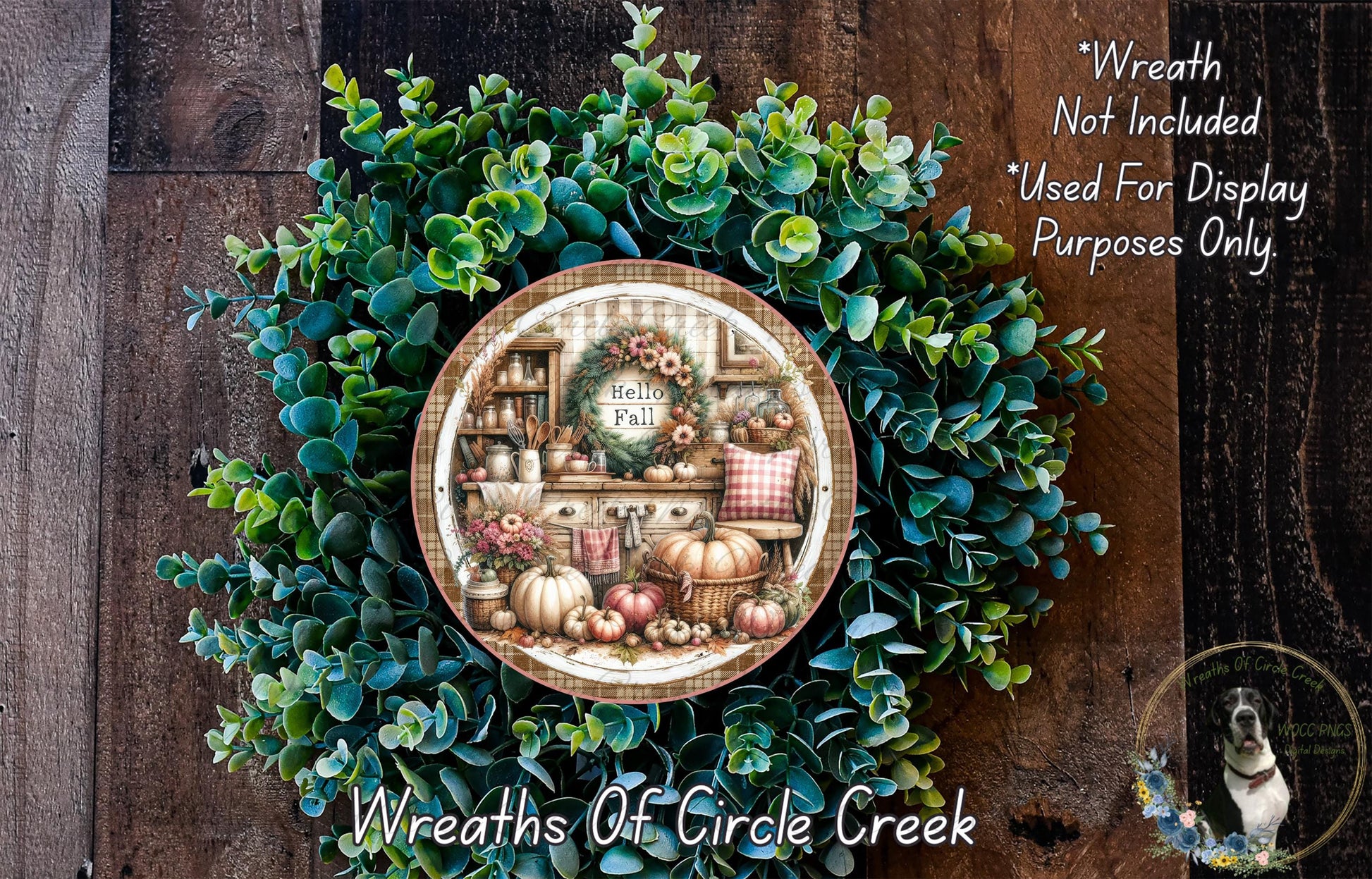 a wreath with a decorative plate containing a fall-themed illustration of pumpkins, gourds, and other fall-related items. The wreath is surrounded by a lush green plant, and the plate is placed on a wooden surface.