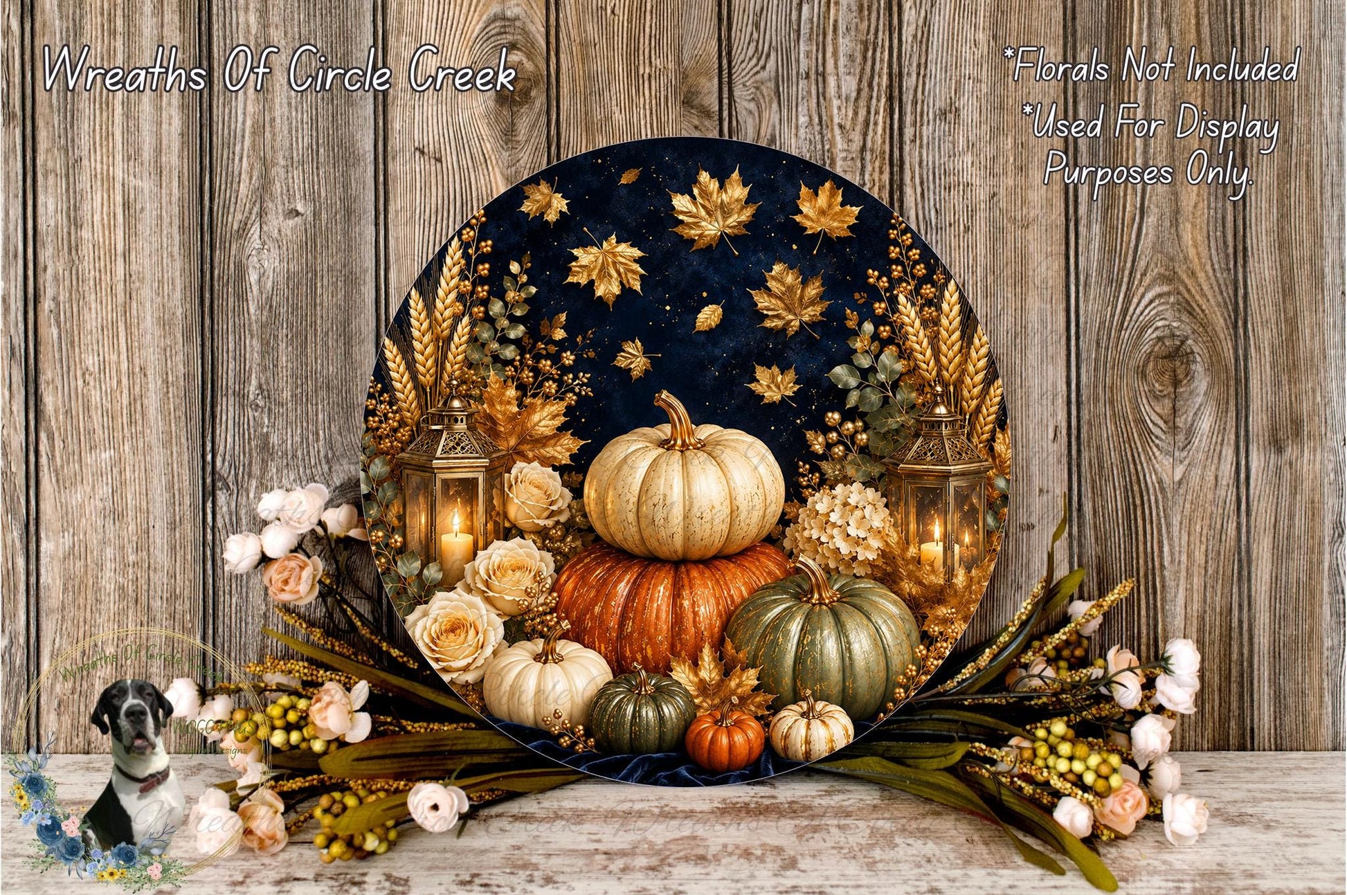 A decorative arrangement of pumpkins, flowers, and lanterns on a wooden surface, with a dark background featuring gold leaf accents.