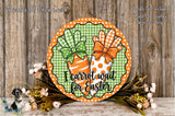 a decorative Easter wreath with a carrot and a bow, placed on a wooden surface. The wreath has a text that reads "I Carrot Wait for Easter".