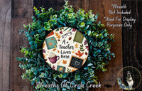 a wreath with a picture of a teacher on it