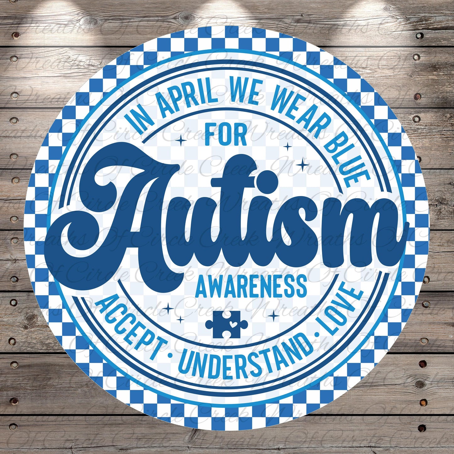 a circular design with a checkered border and a blue and white color scheme. The central message on the design reads "Autism Awareness Accept Love", and there is a puzzle piece symbol in the bottom right corner.