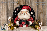 A festive Christmas-themed image featuring a smiling Santa Claus figure holding a mug of hot chocolate, surrounded by a wreath of flowers and a wooden background.