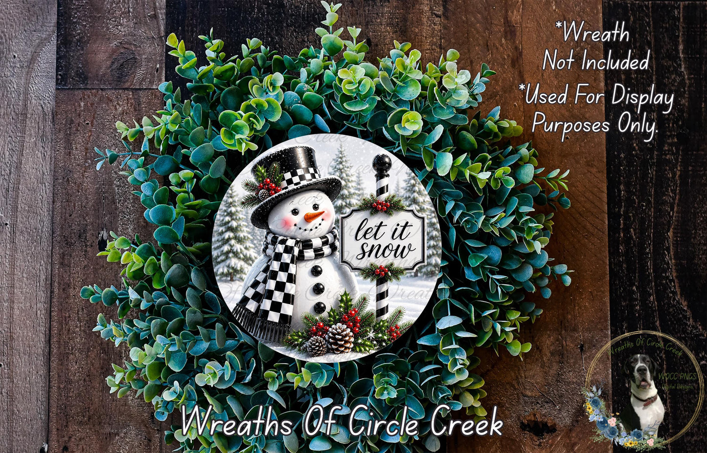 A wreath made of green foliage and featuring a snowman with a sign that says "let it snow".