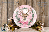 a round, pink-colored wreath with a deer head and antlers, surrounded by a floral arrangement and a small bird. The wreath is placed on a wooden surface, and there is a text overlay that reads "Wreaths Of Circle Creek" and "Florals Not Included Used For Display Purposes Only".
