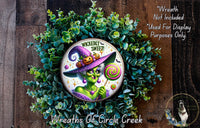 a wreath with a picture of a witch on it