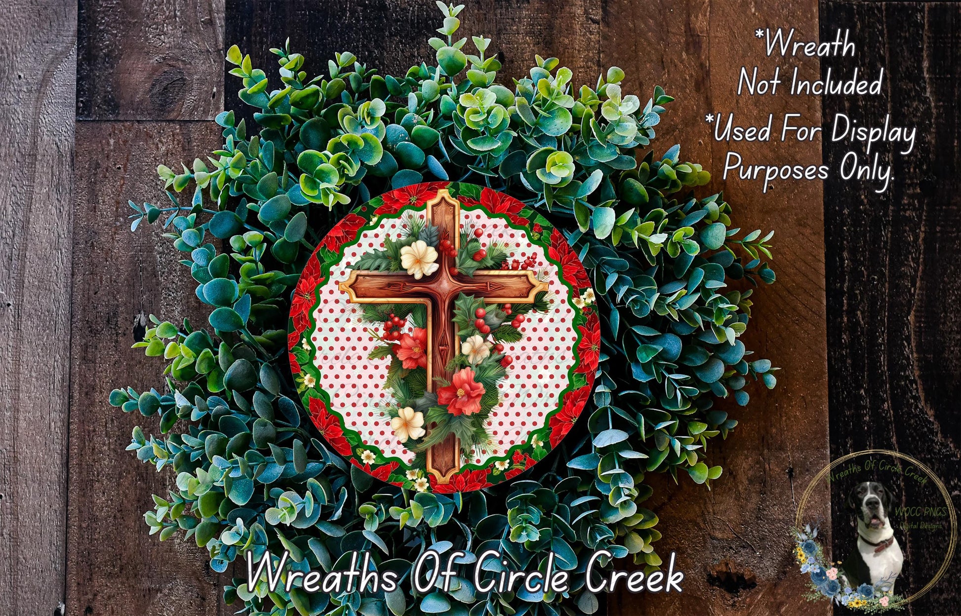 a wreath with a cross and flowers, placed on a wooden surface.