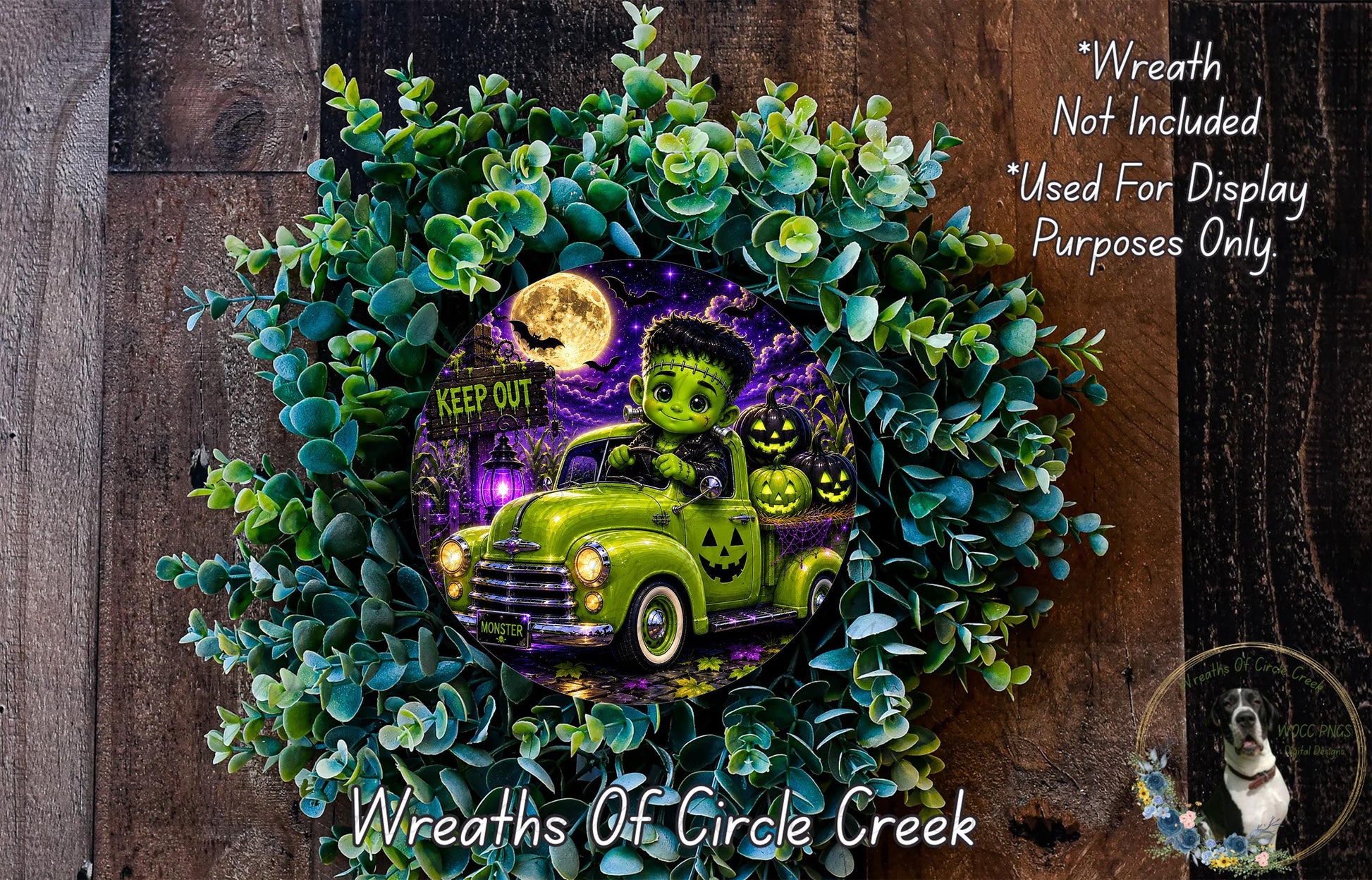 A Halloween-themed wreath featuring a green truck with a ghostly figure, a full moon, and jack-o-lanterns. The wreath is surrounded by green foliage and has a "KEEP OUT" sign on it.